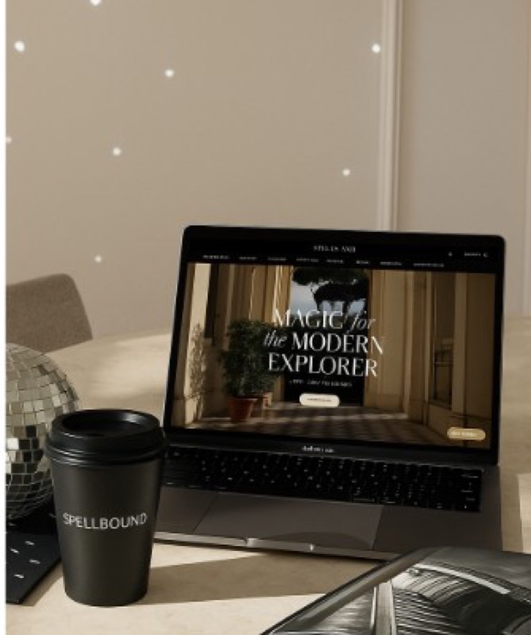A laptop and Spellbound coffee cup